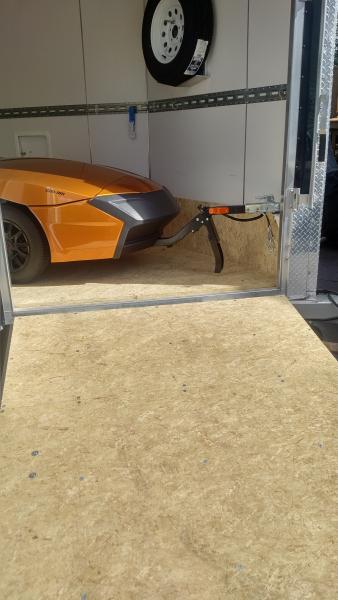 Freedom trailer hitched inside of enclosed trailer