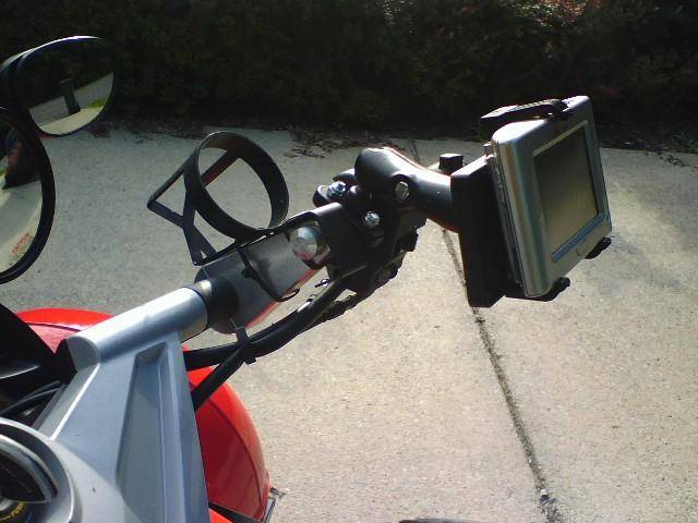 FunkyCupHolder!  Purchased from Pilot Truck Stop.  Cost $1.19 and used two wire ties to secure.  4" bar risers from ESI.  Oh, on the Ram mount the GPS