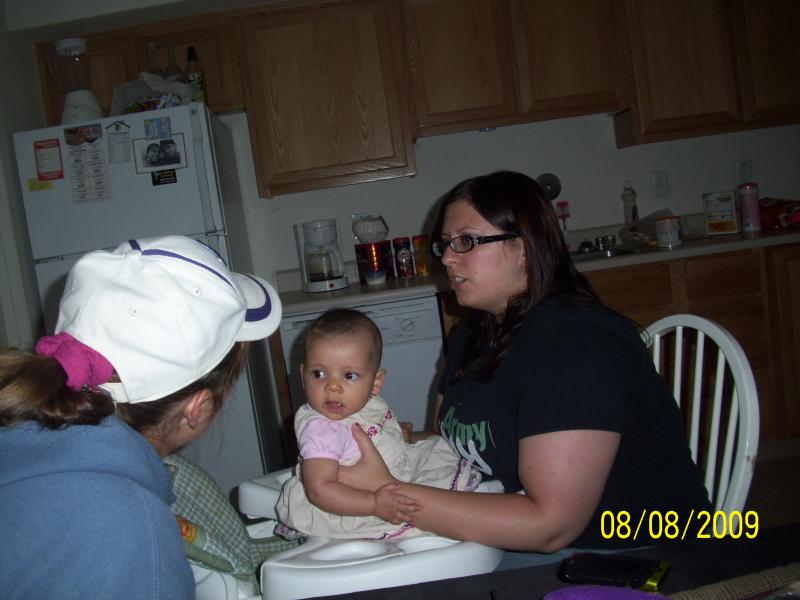 Granddaughter Elysia held by mommy Amy and talking to Aunt Suzanne at Ft Lewis, WA