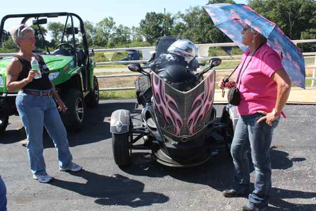 Linda Austin (L) and Flamingo Babe admire the new flamingo umbrella that Linda bought her.