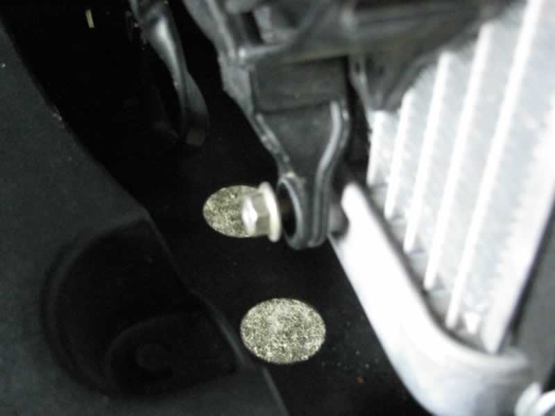 Loosen lower right fan mounting bolt