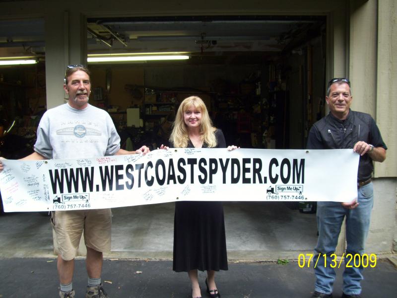 Lou, Kim, and Mike with the banner.