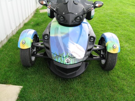 My riding buddies named the front trunk to the 'Frunk'. There is an silhouette of a batter swinging at a ball in the moonlight