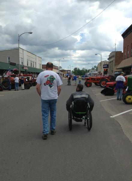 My two guys checking out the street vendors, bikes, tractors and cars in Grantsburg, WI