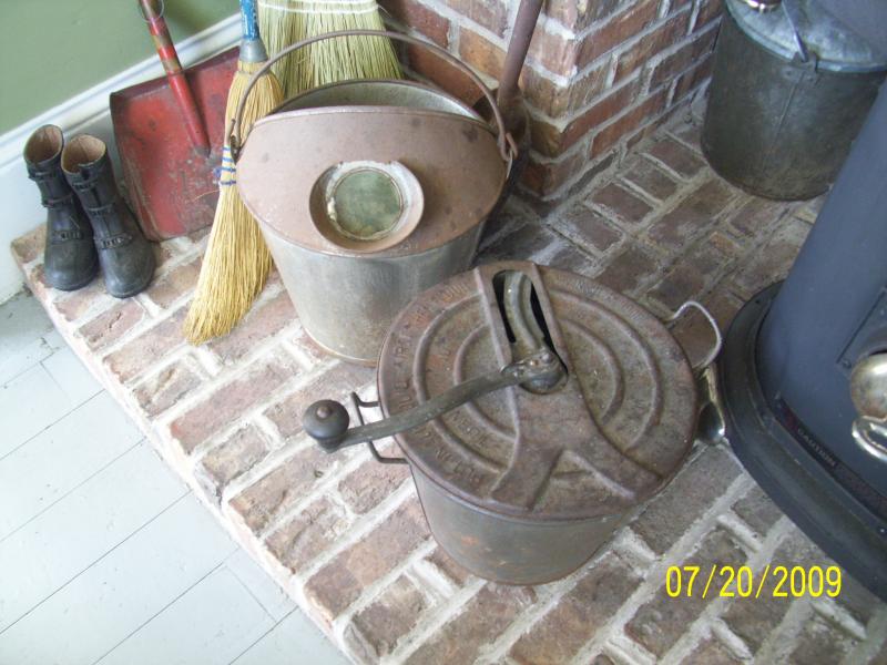 Old time bread machine. Has instructions about adding flour and stuff on the lid. Bucket and wood stove.
