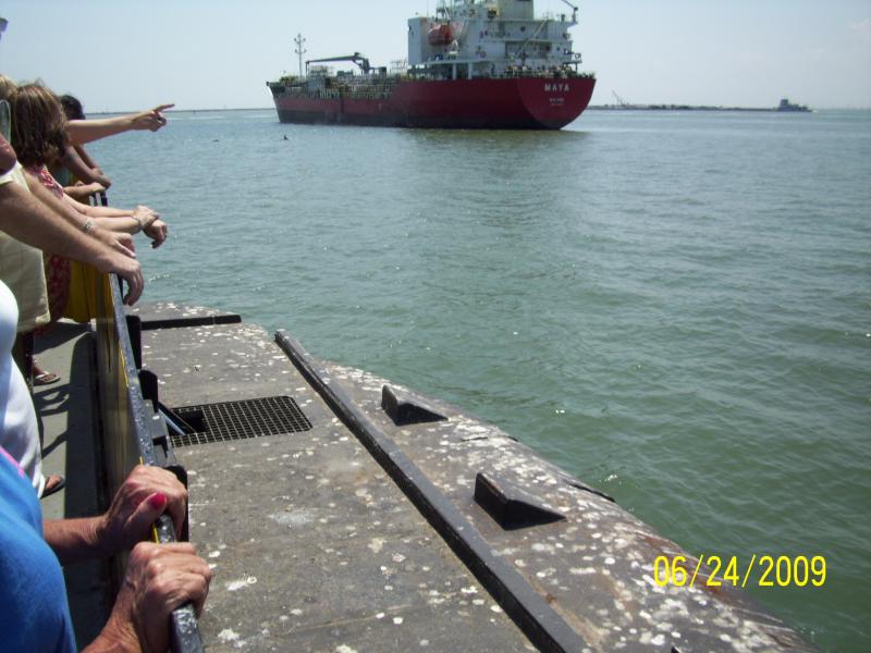 On the ferry between Galveston and Bolivar Peninsula.  The two black dots near the ship are porpoises.