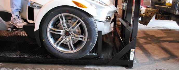 Pictured here, the vertical bar in front of the front wheel prevents the Spyder nose from touching the bulkhead.