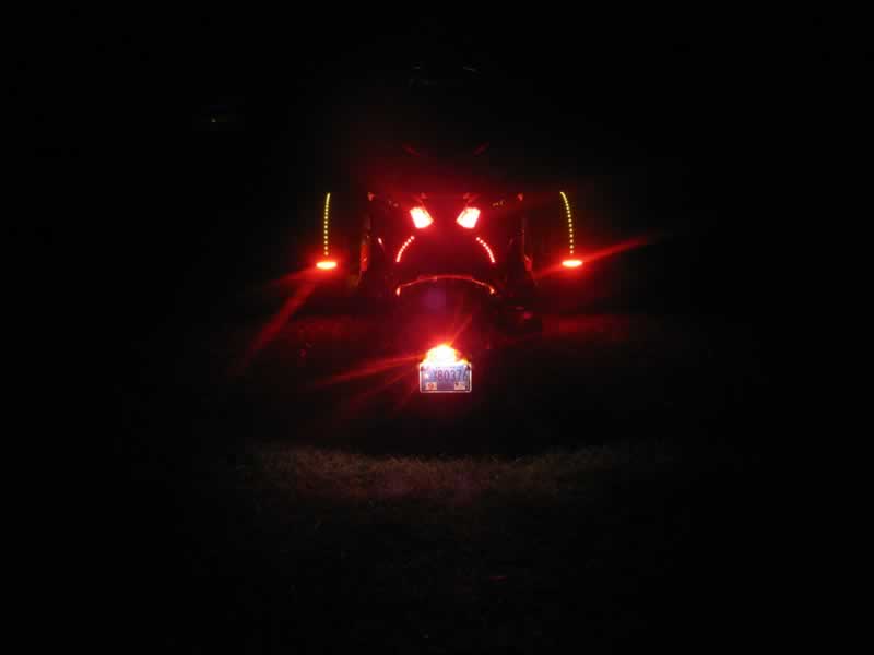 Rear view of red LED lights under seat that function as running and brake lights, along with Fenderz and ESI Mud Flap Lights.
