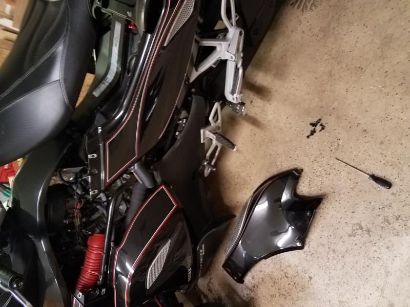 Remove the left center panel, raise the seat and remove the left rear panel and for a best view remove the lower airdam as well...