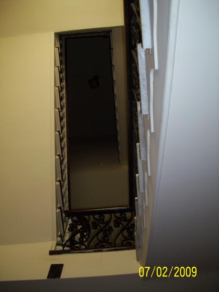 Stairwell looking straight up from the bottom floor.  The mansion has no elevator.  The owner, in his 70's still uses the stairs.  The top two stories