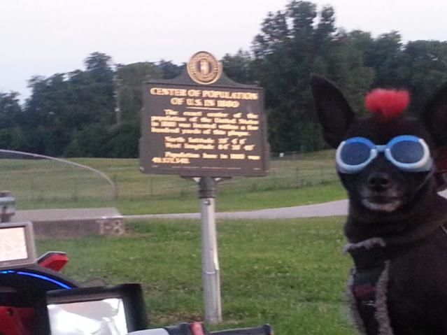 Teddy ryde'n redneck style with a stripped sled at the airport viewing area & marker showing the area was the center of population back in 1880
