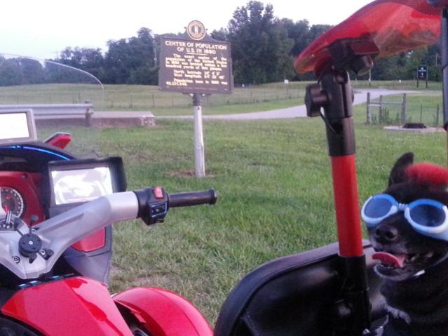Teddy ryde'n redneck style with a stripped sled at the airport viewing area & marker showing the area was the center of population back in 1880