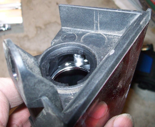 That flange at the top of the pic is in the way. It stops you reaching the bulb holder from below. It has to go...