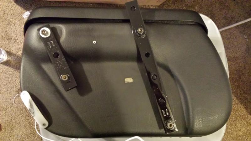 The bolt holding the silver washer is just there to position the bracket. It is removed and replaced with a longer bolt and the bracket and bag are at