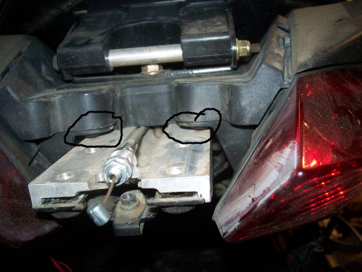 The "circles" show why this mod is worth doing. The two inner screws that mount the taillights are obscured by the plate that supports the sport rack.