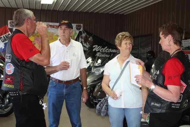 The Glory Riders in their black vests talk to some newer riders from Owensville, Missouri.