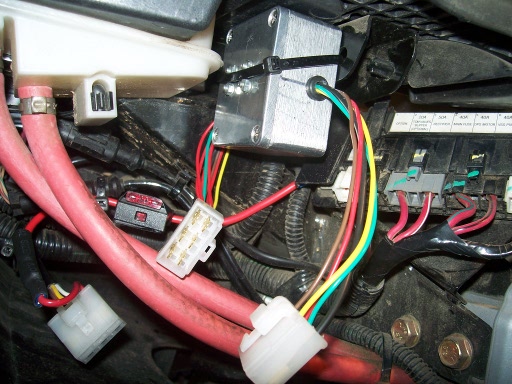 The isolator box mounted to a bracket under the seat. The isolator contains a fet switch and four mosfets to isolate the trailer wiring, particularly 