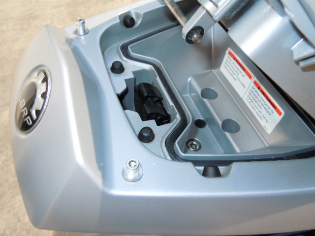 The screws and spacers installed. The bottom cover of the sport rack must be removed to install self locking nuts on the screws. The cover is held on 