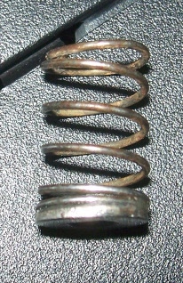 The washer glued to the spring. Take care to clean up any excess glue, or it will bind in the spring well,