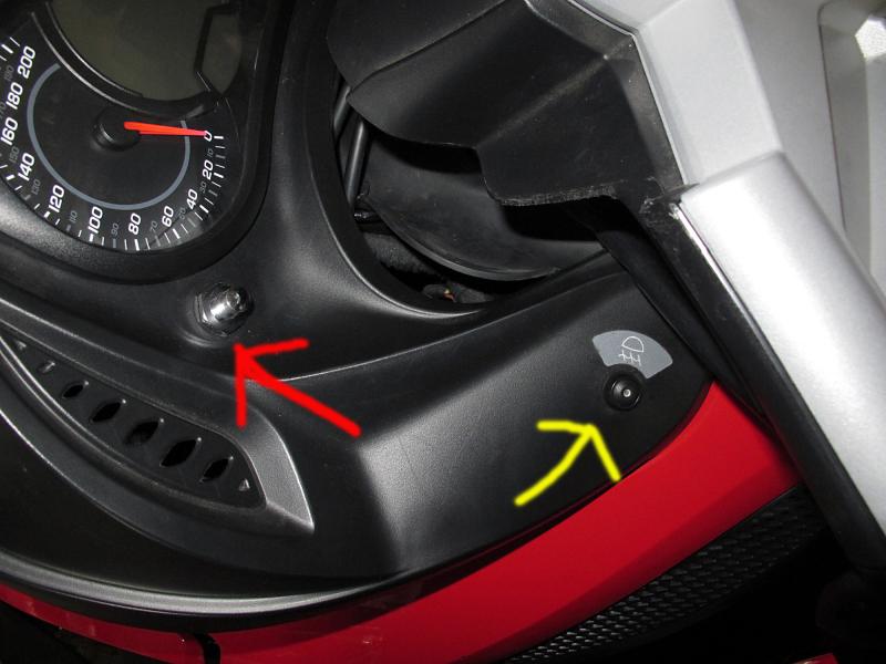 This is a shot of the switch our dealer put on for my garage door remote. The red arrow points to the new switch (chrome) - the yellow arrow points to