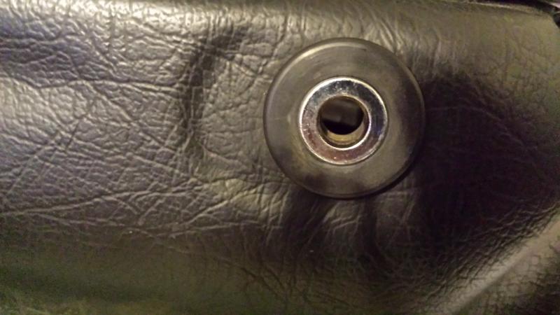 Use 1/2" spacer in factory grommet on front of bag to attach bracket and bag to the front grab bar mount.