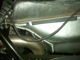 Wiring harness on left side against fuel tank.